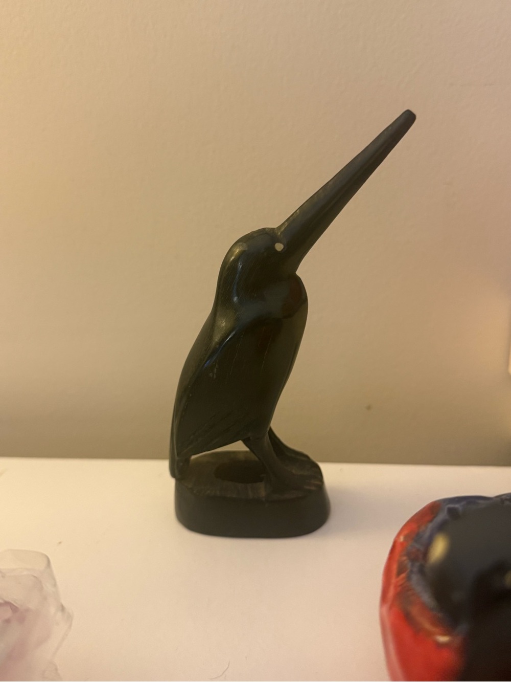 black carved bird sculpture made from natural horn